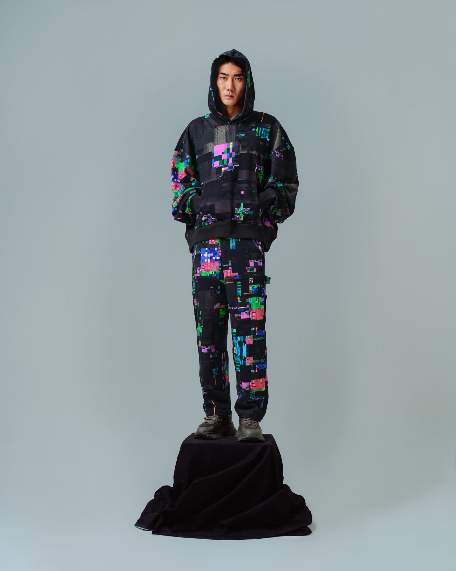 man wearing a glitchy hoodie and glitchy sweatpants
