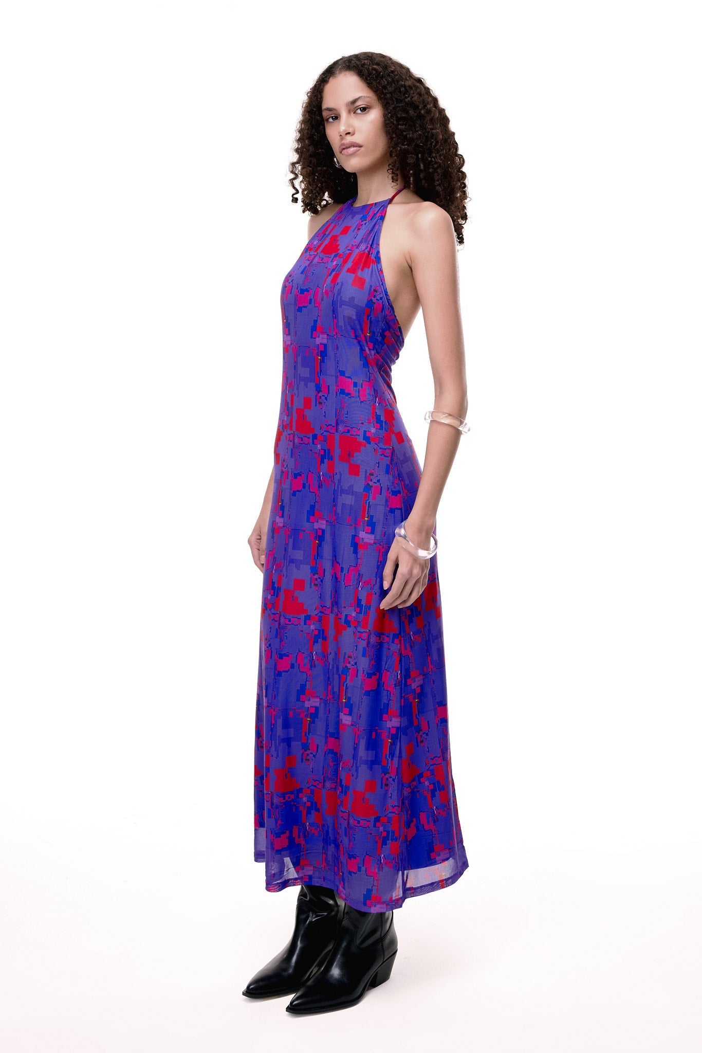 Woman standing with high heel boots and gloves with skirt and green t-shirt