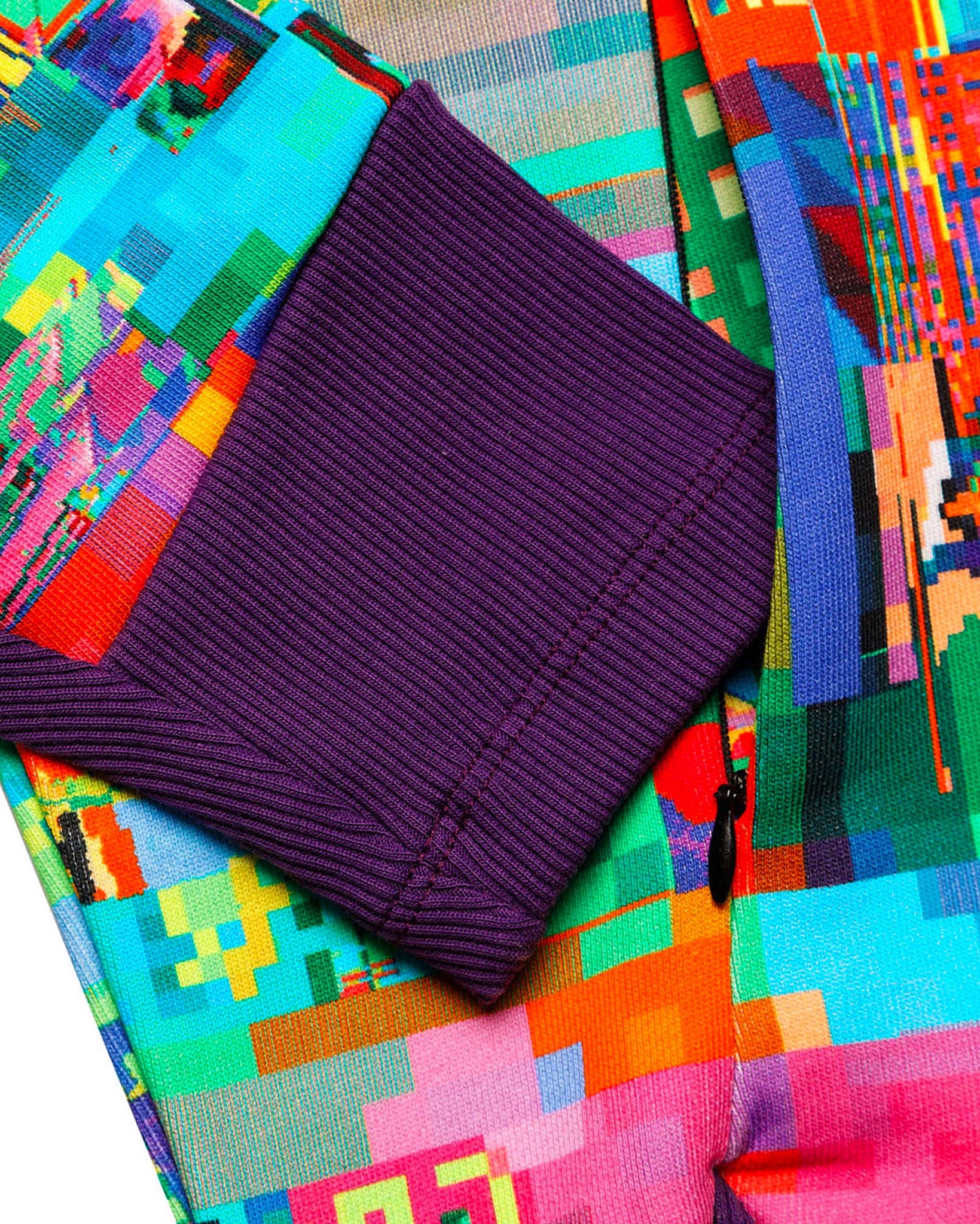 Purple fabric with colorful geometric patterns in the background