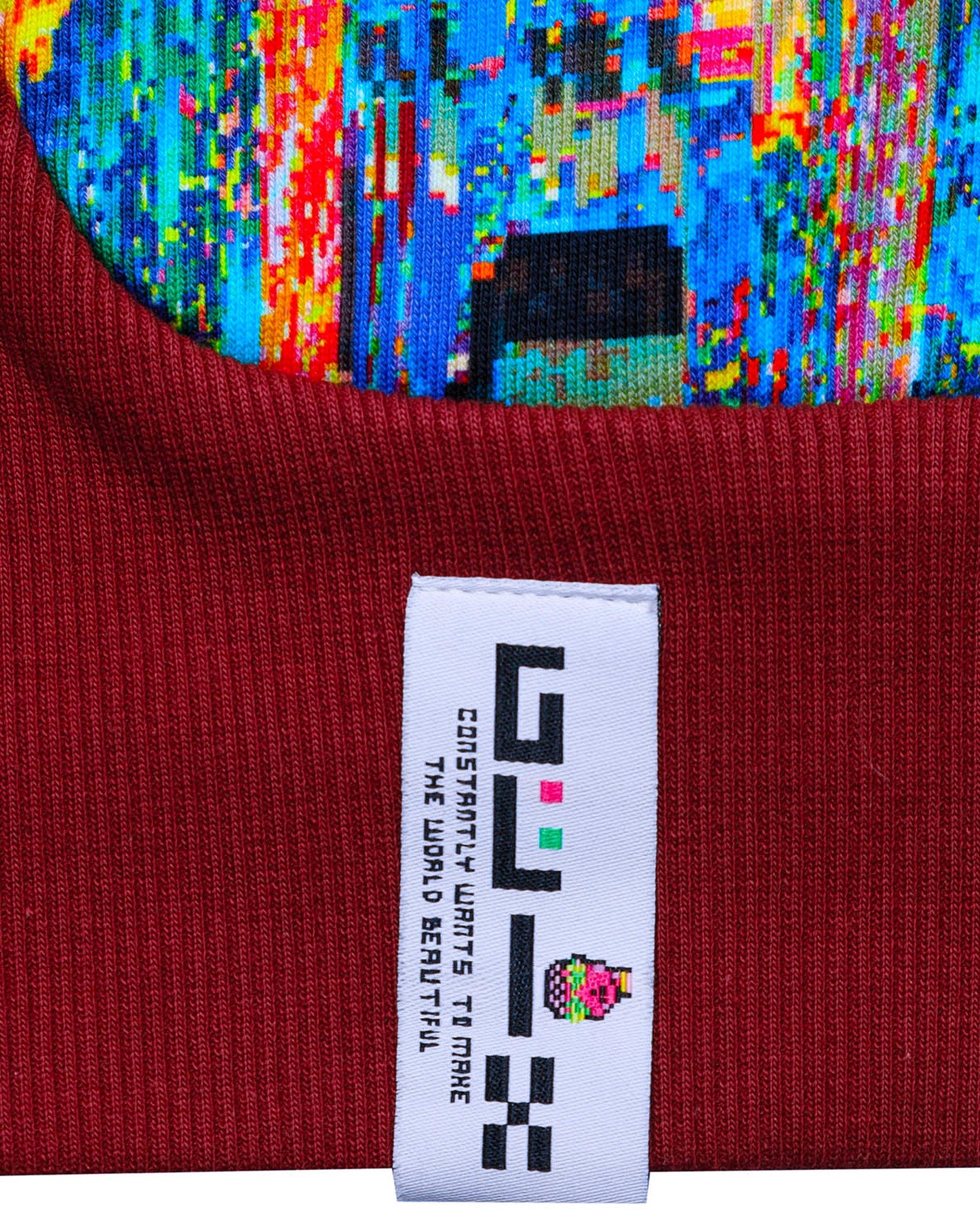 Close-up of a red fabric with a Glix label against a colorful, pixelated background.