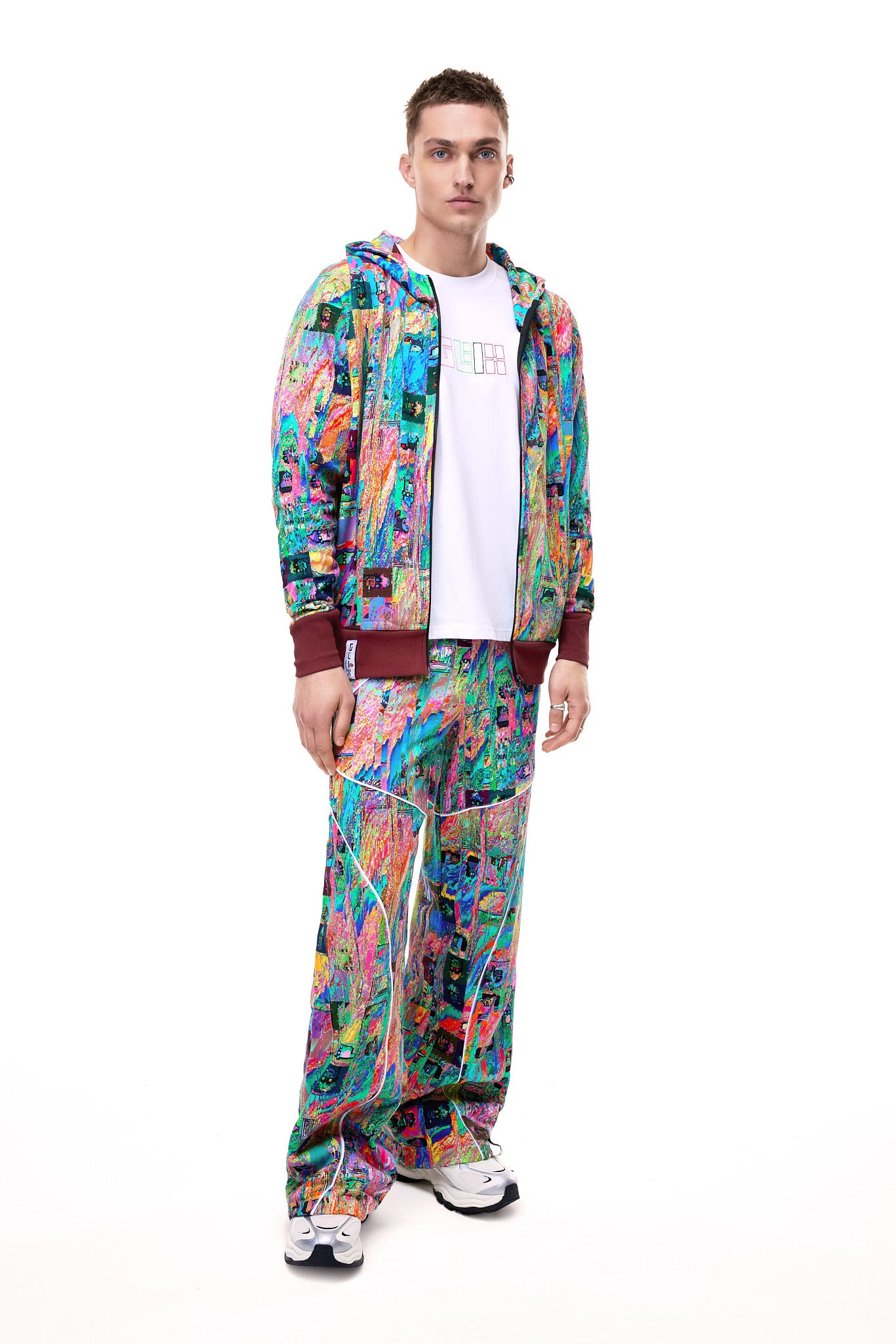 Person wearing a colorful tracksuit with a white background