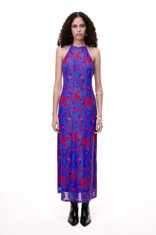 Woman wearing a purple and red patterned dress on a white background. Product is #404.BLUSH from GLIX.