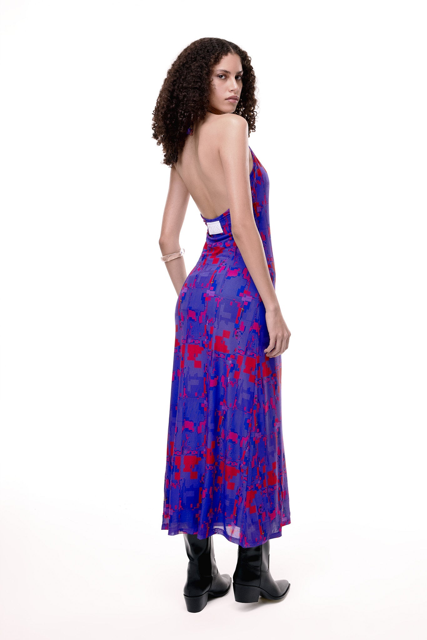 Woman wearing a purple and red patterned dress on a white background. Product is #404.BLUSH from GLIX.