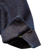 Macro close-up of the adjustable button cuff on the GLIX "Totem" denim crop bomber jacket, showing the dark wash denim texture, precise contrast stitching, and a glimpse of the neon green internal lining.