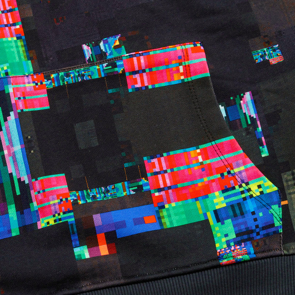 Close-up of the GLIX "Screen Error" hoodie showing the high-definition digital glitch print across the kangaroo pocket and ribbed waistband, featuring vibrant red, blue, and green pixelated blocks on black fabric.