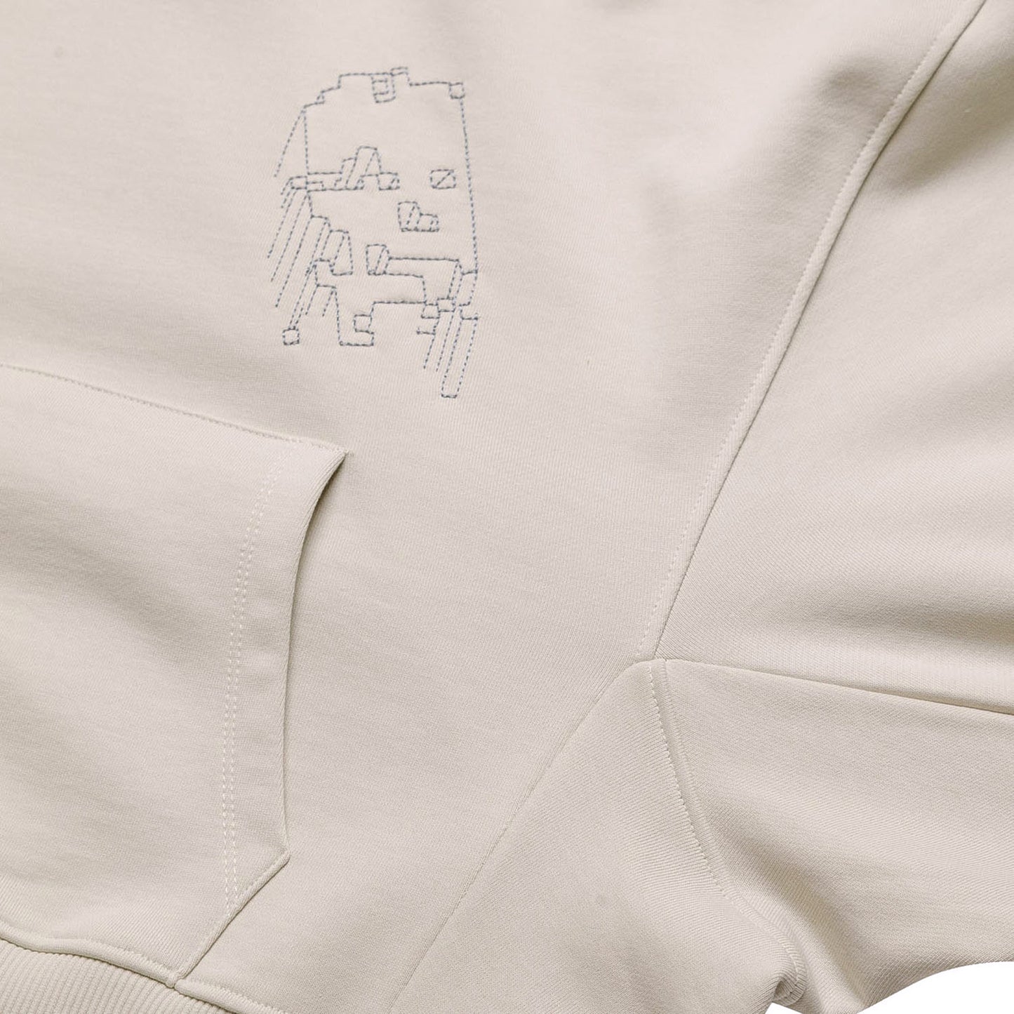 Front flat lay of the light grey GLIX "Grey Matter" oversized hoodie, featuring a small grey digital glitch embroidery on the left chest and a large kangaroo pocket.