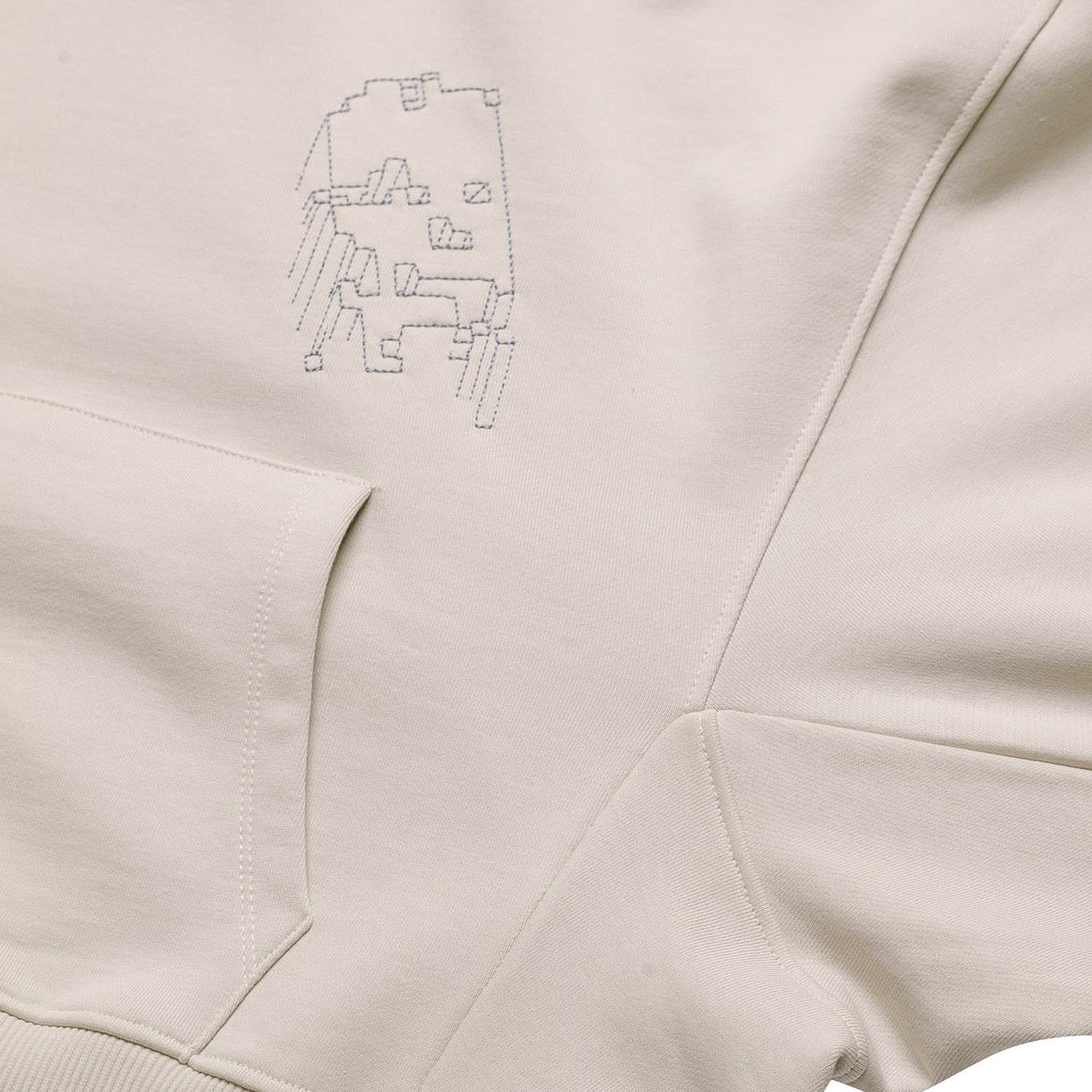 Front flat lay of the light grey GLIX "Grey Matter" oversized hoodie, featuring a small grey digital glitch embroidery on the left chest and a large kangaroo pocket.