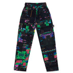 Front flat lay view of the GLIX "Screen Error" oversized sweatpants, featuring an all-over dark digital glitch print with neon green and blue pixelated accents, an elastic waistband with neon green and blue drawstrings, and reinforced knee paneling.