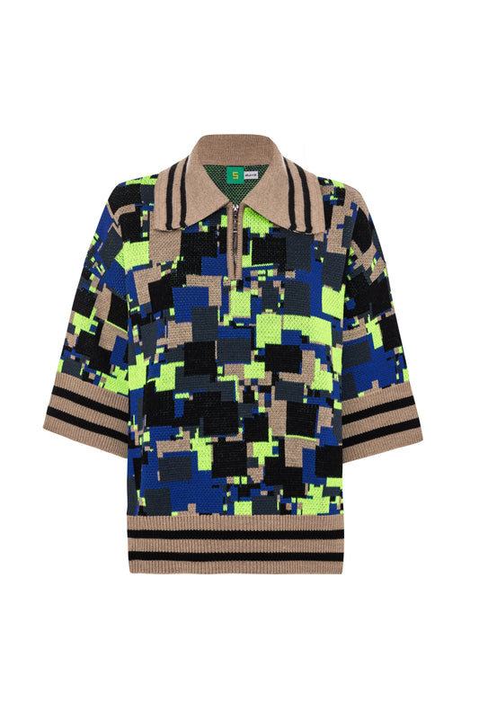 Front flat lay view of the GLIX "No Knit" oversized short-sleeve jacquard knit polo sweater on a white background, featuring an all-over pixelated glitch pattern in cobalt blue, neon yellow-green, black, and camel, with a camel-and-black striped ribbed hem and cuffs, camel polo collar with black stripe trim, half-zip closure, and a green internal lining visible at the neckline.