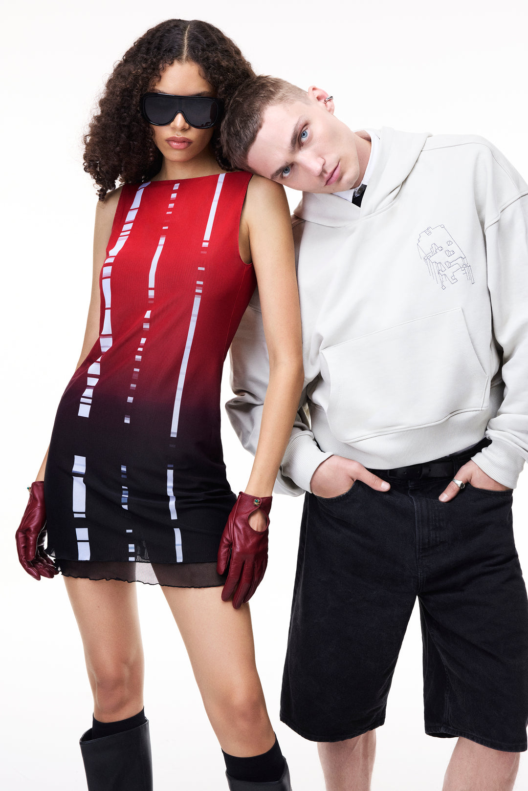 Model wearing a GLIX sleeveless mini dress with a red-to-black gradient and vertical white glitch-style dashed stripes.