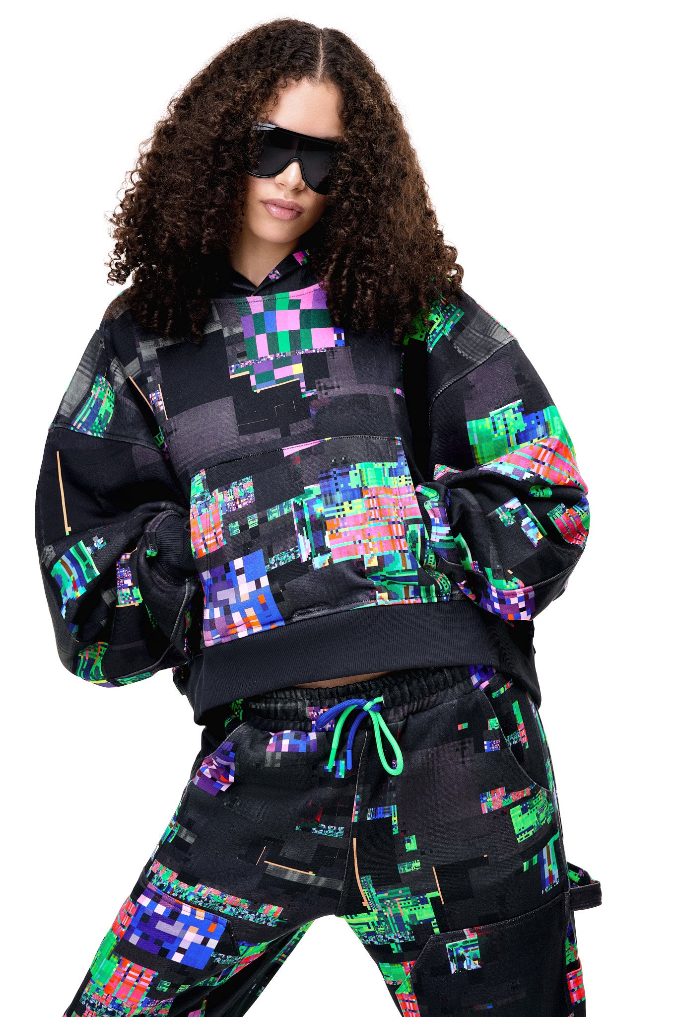 Close-up of the GLIX SCREEN ERROR hoodie and matching sweatpants, highlighting the intricate digital distortion print and heavyweight cotton texture.