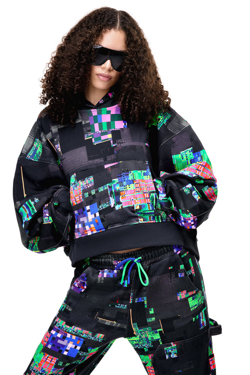 Close-up of the GLIX SCREEN ERROR hoodie and matching sweatpants, highlighting the intricate digital distortion print and heavyweight cotton texture.