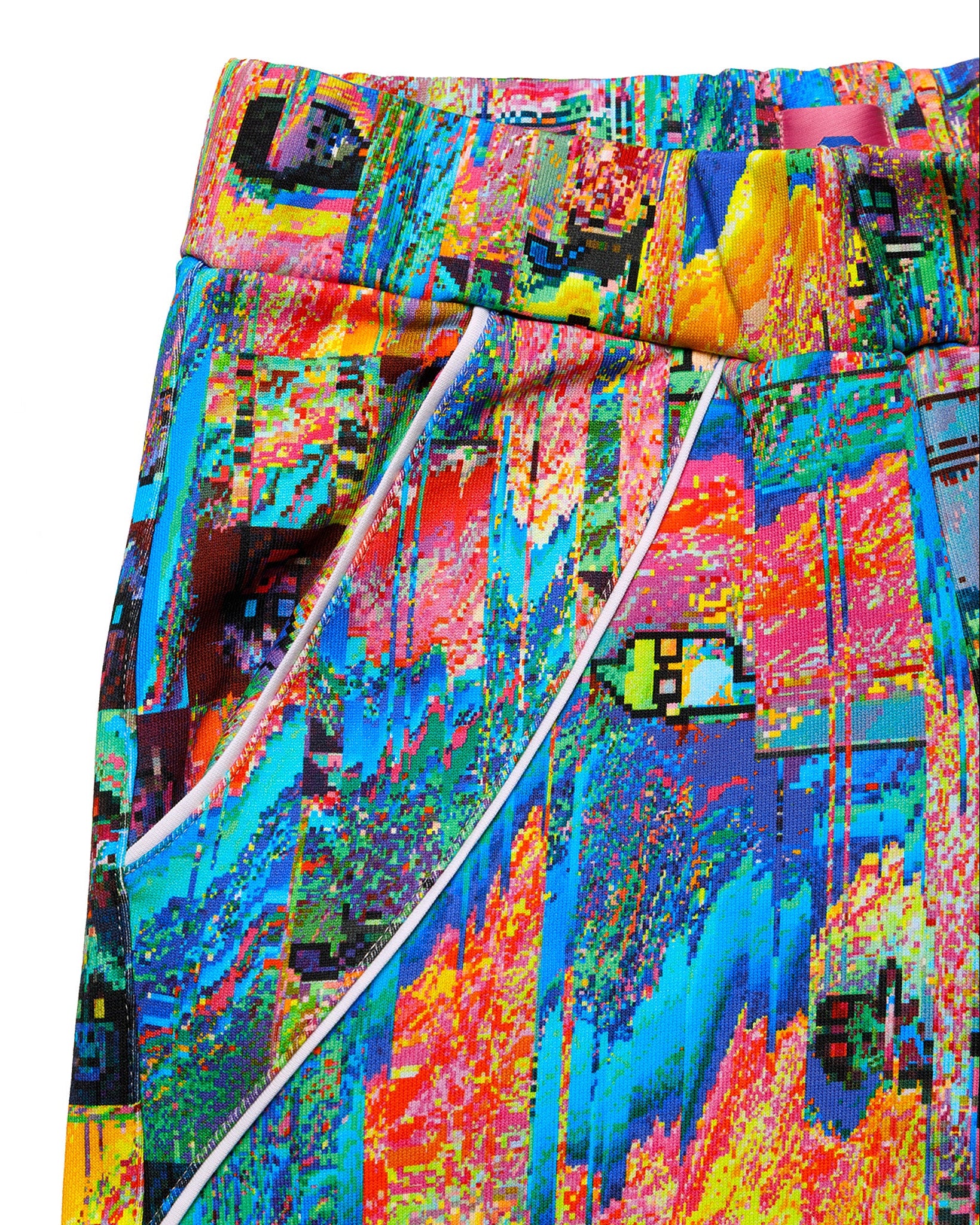 Macro close-up of the GLIX "Mudderrrfall" sweatpants, highlighting the elasticated waistband and a side pocket accented with curved white piping against the vibrant multicolor liquid digital glitch print.