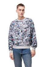Front view of a male model wearing the GLIX "Colors' Echo" grey oversized sweatshirt, showcasing the intricate all-over multicolor digital glitch and pixelated print with a thick ribbed grey crew neckline and cuffs.