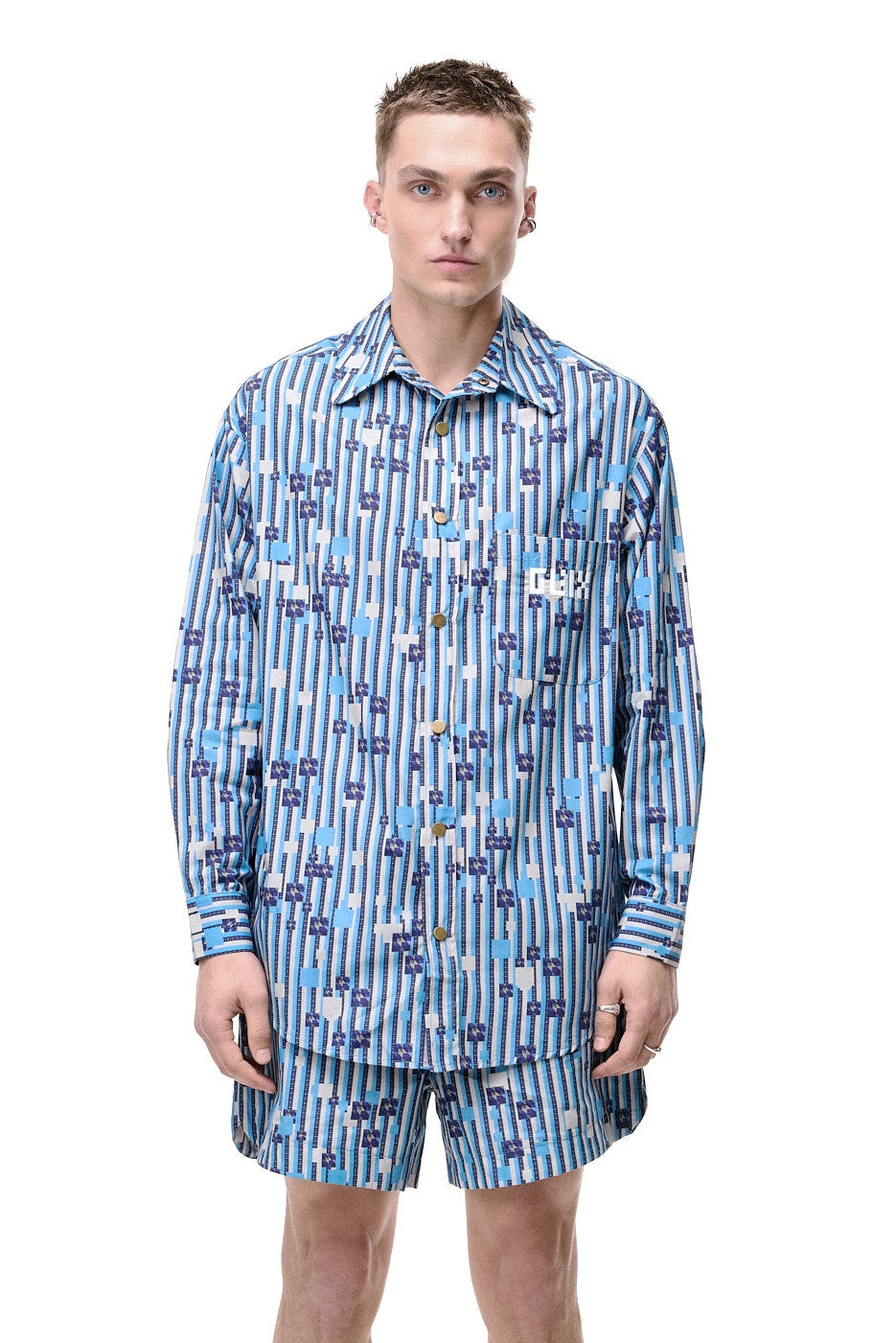 Front view of a model wearing the GLIX WATER CRACKLE button-down shirt featuring a blue and white generative digital pattern.