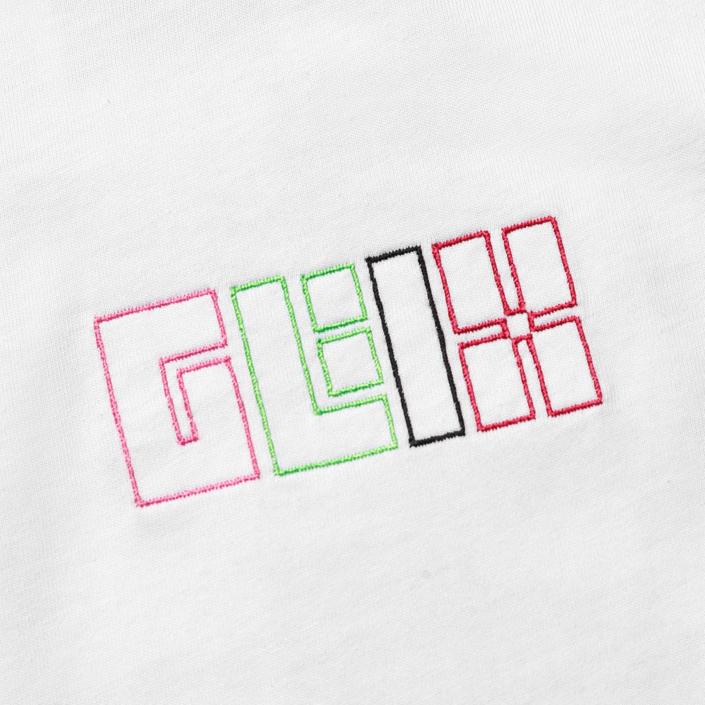Close-up of the GLIX logo embroidered in pink, green, black, and red thread on the front of a white cotton crop top baby tee.