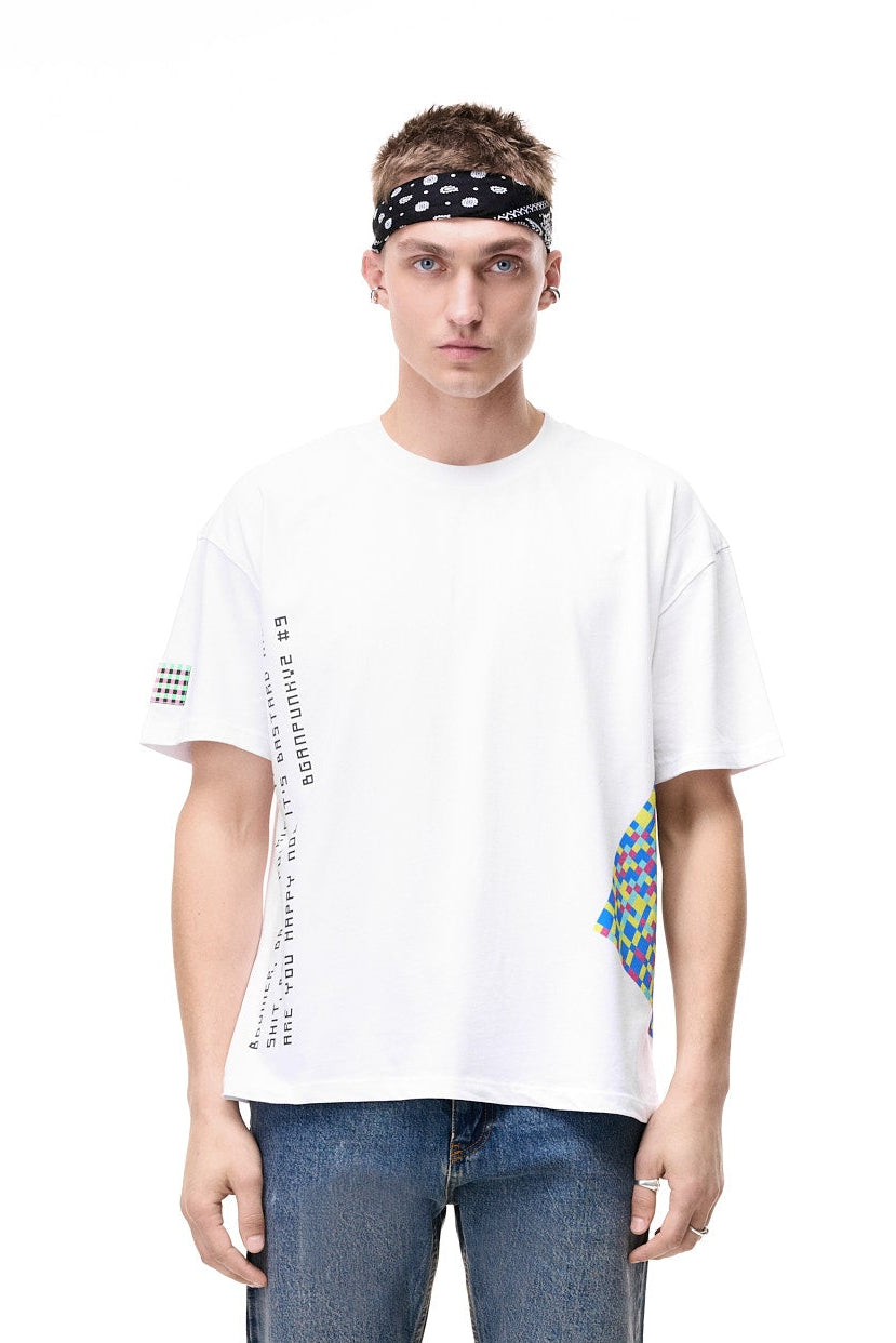 Front view of a male model wearing the white GLIX oversized t-shirt, featuring vertical text graphics on the right and a colorful pixelated triangle on the hem, styled with a black patterned bandana and blue jeans.